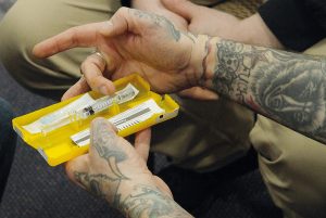 Hands with a naloxone kit