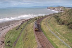 Turning Point residential drug treatment and Cumbria Rail - Showing a train by the coast