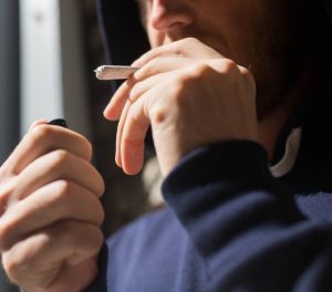 man smoking a joint