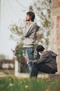 2 men smoke a joint